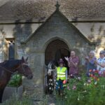 a horse and people stand in front of St Marys church