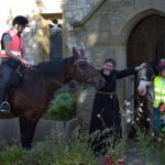 Vicar cheerfully welcoming the horse riders